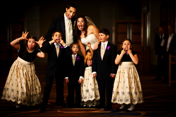 photo by Chicago based wedding photographer Kevin Weinstein - adorable group portrait of bride and groom with flower girls and ring bearers 